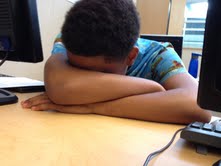 A student dozing off during a class. 