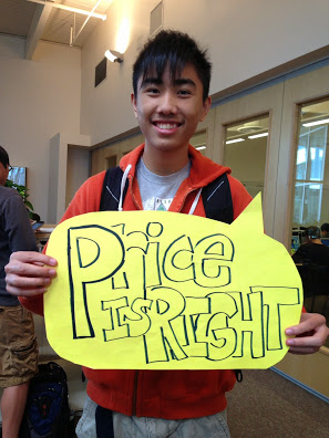 ABOVE: Senior Kun Liu holding a sign for a civics project.