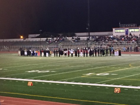 Drum majors and color guard captains from each school stand in anticipation during the awards ceremony