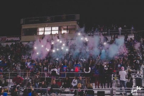 DHS students do a powder toss to support their team at Senior Night.