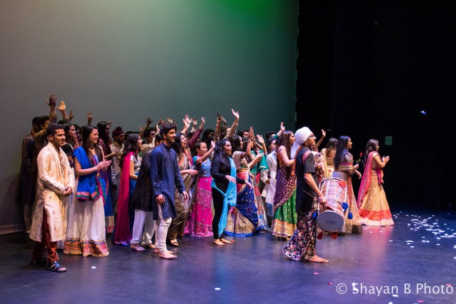 All the participants of the fashion show together on stage.