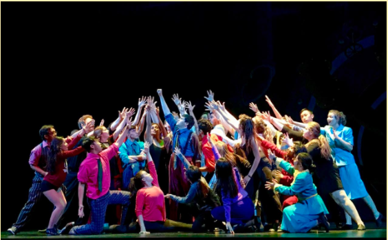 The cast of Guys and Dolls strike a pose at the end of the musical number “Crapshooter’s Dance.” 