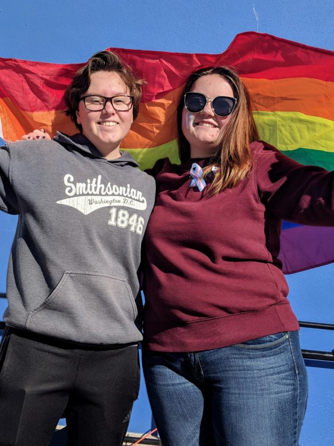 Students raise the LGBT+ flag as a symbol of their support.