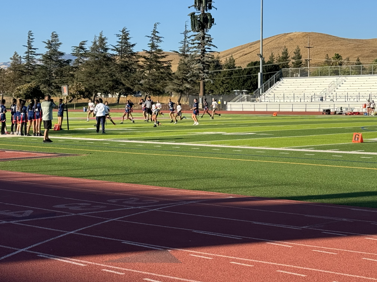 Girls Flag Football playing strong defense to stop the other team from scoring a touchdown. 
