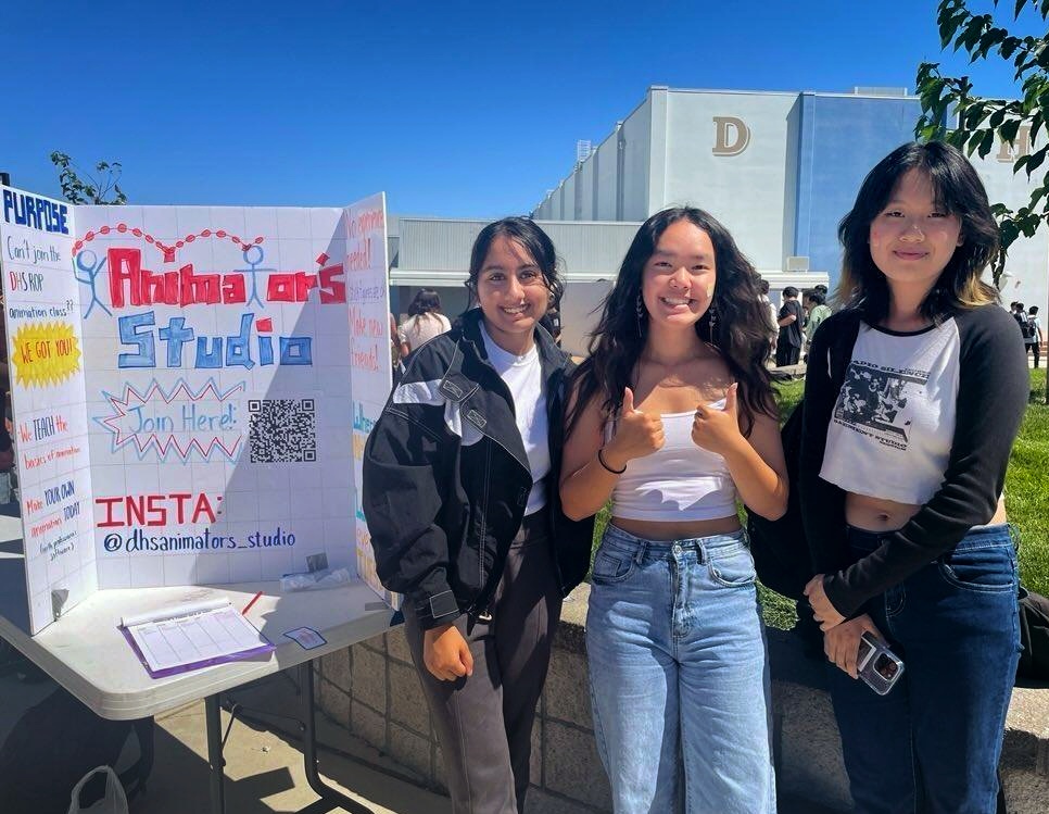 Dublin High Students Anjali Zalani, Kaylee Tran, and Adrienne Guan pose next to their club fair trifold for DHS Animators Studio during lunch on September 8th. (Photo by Austin Meng)