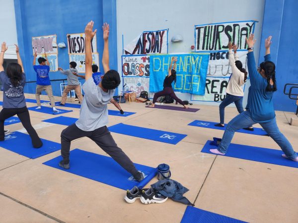 DHS Students follow yoga instructor Ms. Kavita Patel in a warrior pose during a yoga and meditation event during lunch.