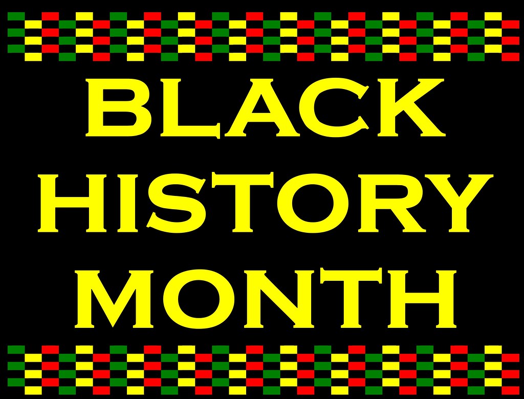 Sign that promotes Black History Month. It uses the colors red, green, and yellow to symbolize the blood, rich greenery, and optimism of African Americans. 