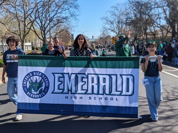 Emerald High School students walking in the parade while holding the school banner.